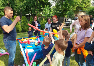 Dzieci skręcają kolorowe baloniki