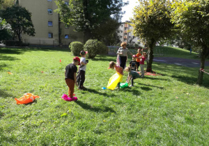 Dzieci w ogrodzie biorą udział w konkurencji sportowej